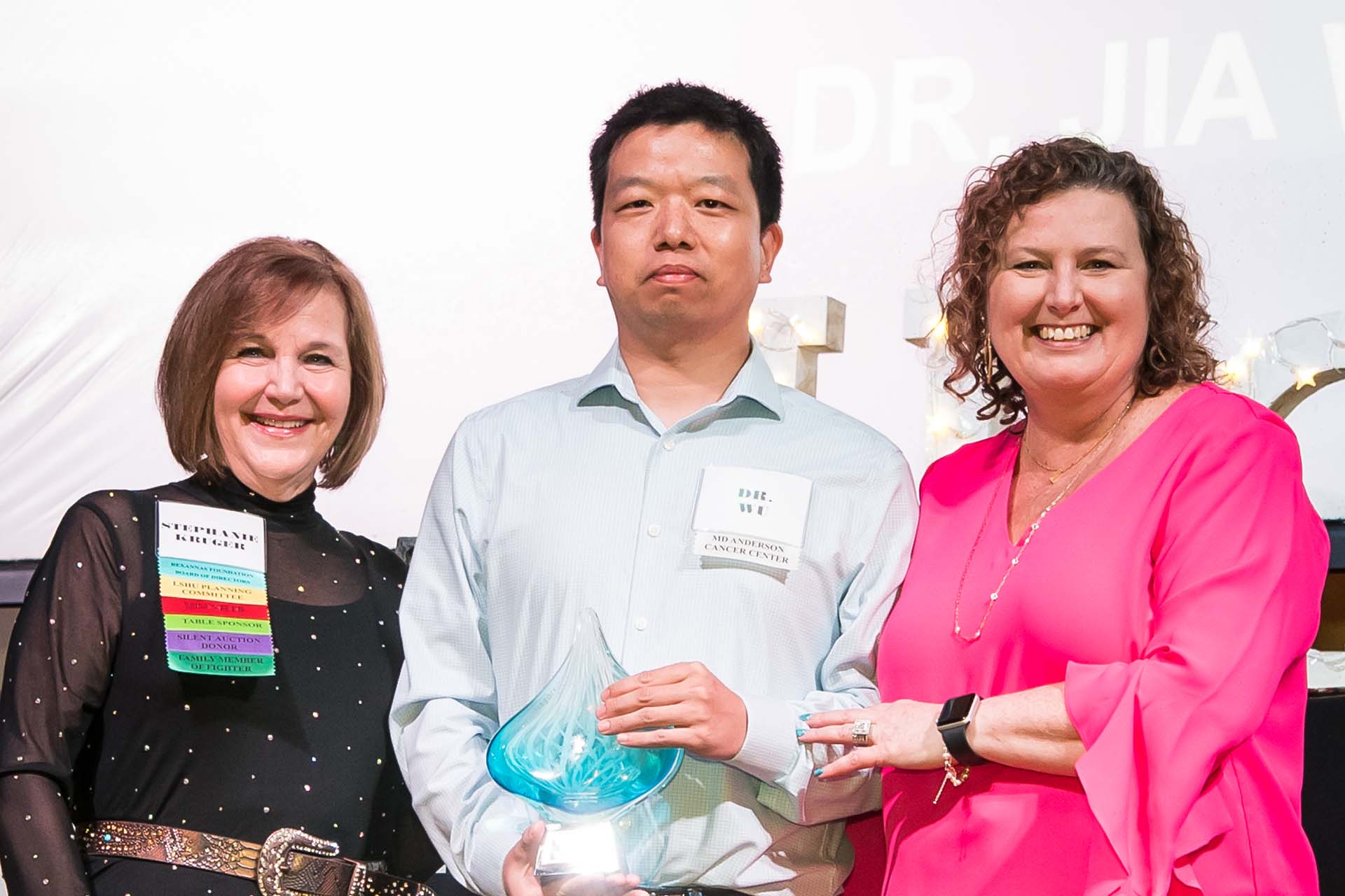Image of Left to Right: Stephanie Kruger (President), Dr. Jia Wu (M.D. Anderson), Lisa Spain (Executive Director)
